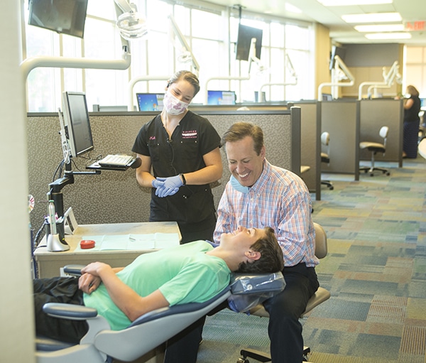 Orthodontist near Hartford, CT, Dr. Rick Risinger smiling while consulting with a patient.