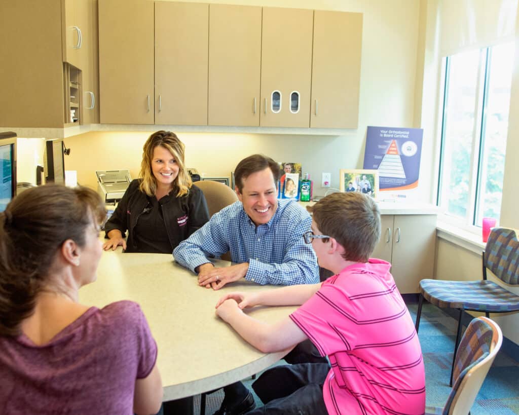 Orthodontist near Hartford, CT, Dr. Rick Risinger consulting with a young patient and his mother.